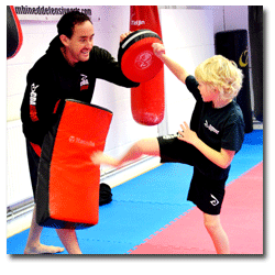 picture of happy children learning kickboxing and martial arts